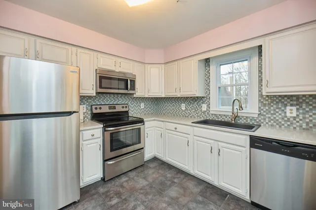 a kitchen with granite countertop a sink and a window