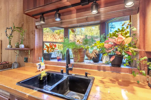 a kitchen with a sink and large window