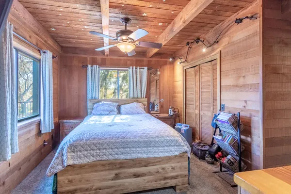 a bed sitting in a room next to a window