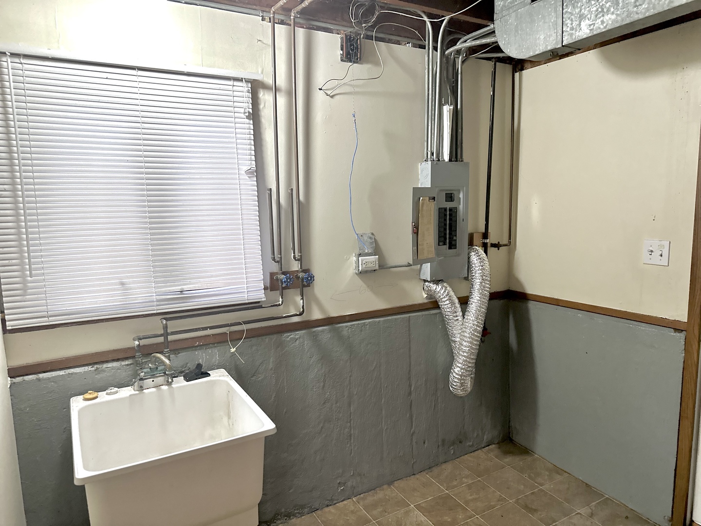 18453 Clyde Road Homewood, IL 60430 - Photo 14 of 15 a bathroom with a sink a mirror and a window
