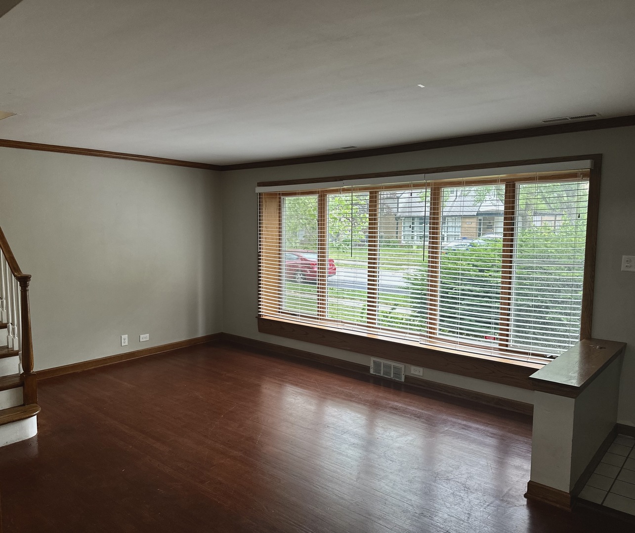 18453 Clyde Road Homewood, IL 60430 - Photo 3 of 15 a view of an empty room with a window and wooden floor