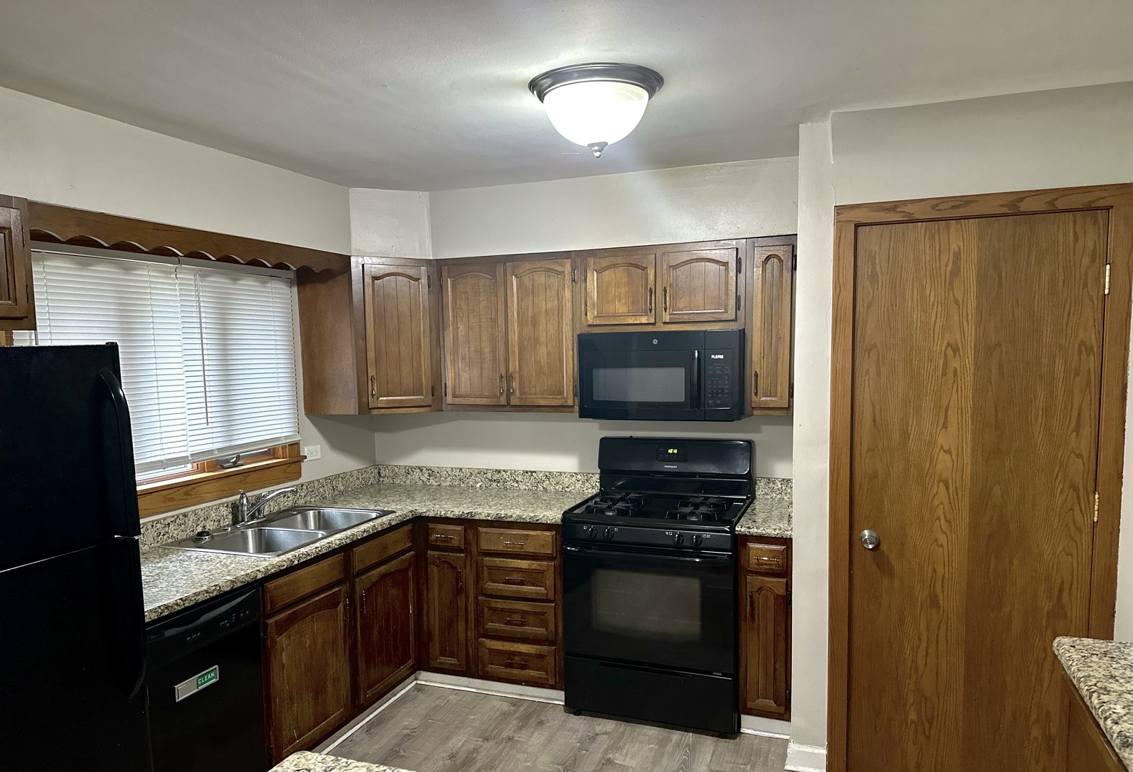 18453 Clyde Road Homewood, IL 60430 - Photo 5 of 15 a kitchen with granite countertop stainless steel appliances and wooden cabinets