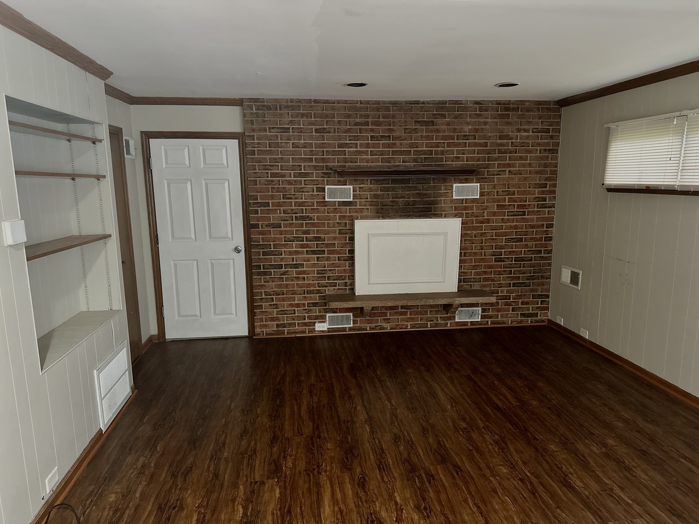 18453 Clyde Road Homewood, IL 60430 - Photo 7 of 15 a view of an empty room with wooden floor and a window