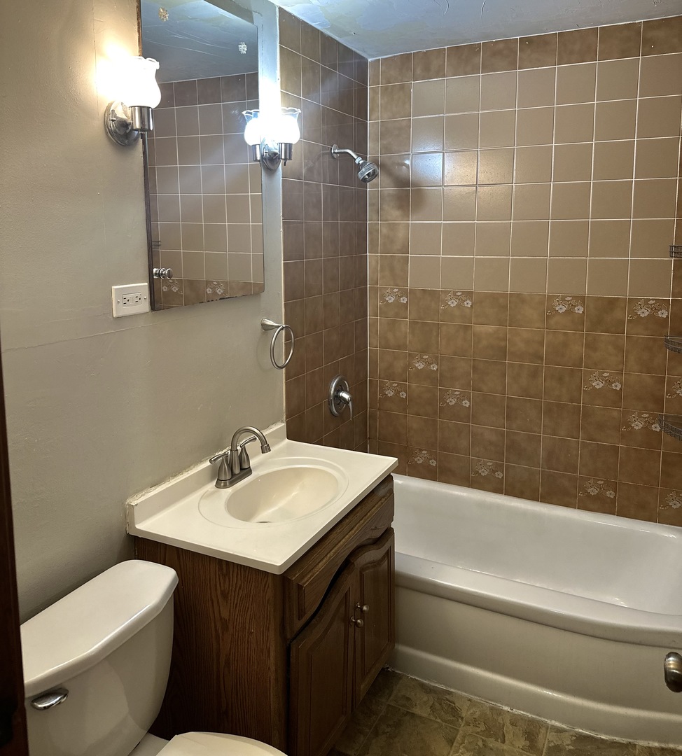 18453 Clyde Road Homewood, IL 60430 - Photo 10 of 15 a bathroom with a sink and a mirror