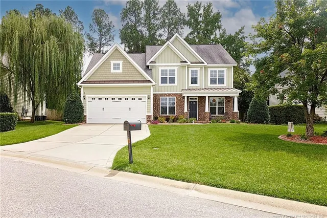 a front view of a house with a yard table and chairs