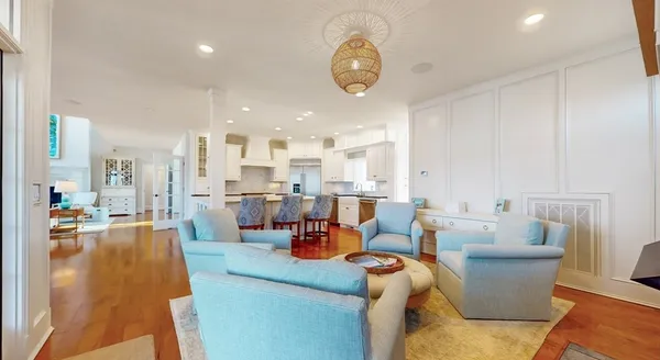 a large kitchen with stainless steel appliances kitchen island granite countertop a large kitchen island a stove a refrigerator and white cabinets