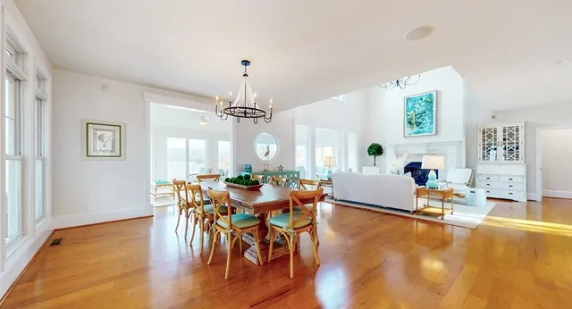 a large kitchen with stainless steel appliances granite countertop a lot of counter space and wooden floor