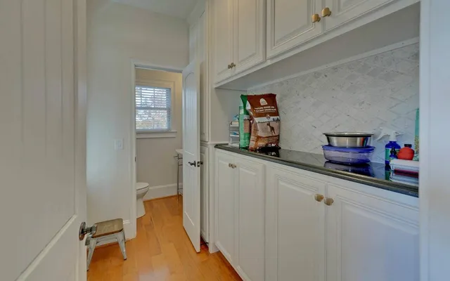 a bathroom with a toilet a sink and a window