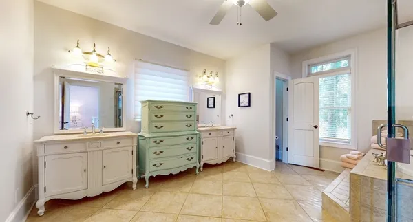 a bedroom with a bed and a ceiling fan