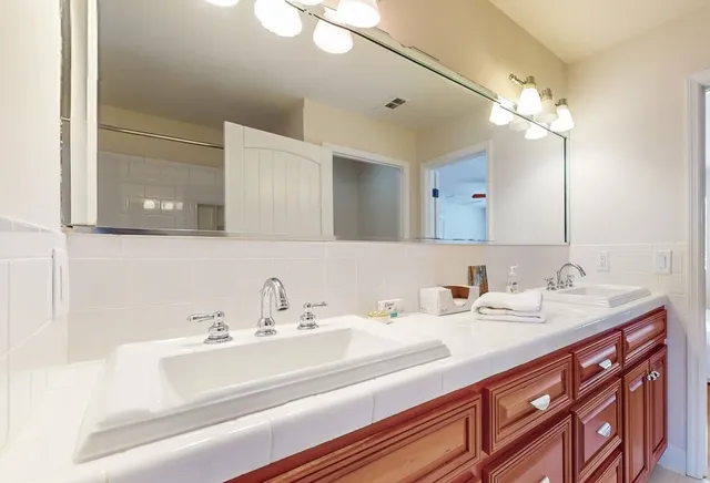 a living room with furniture ceiling fan and a flat screen tv