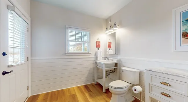 a view of a dining room with furniture a chandelier and wooden floor