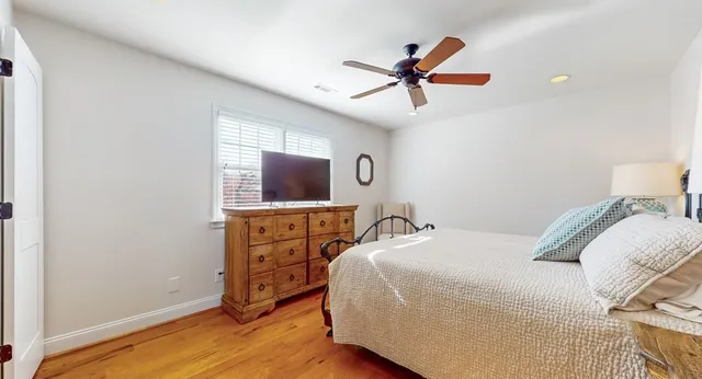 a living room with furniture a window and a flat screen tv