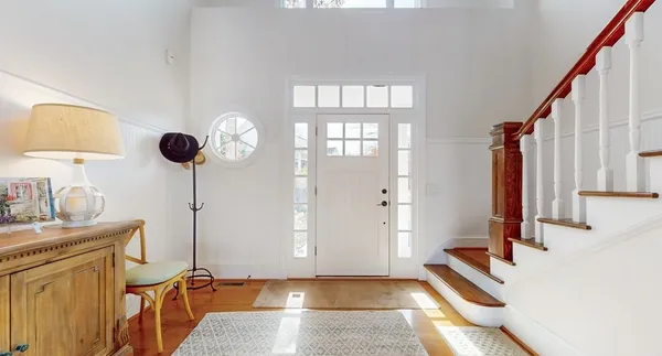 a living room with furniture a fireplace and a chandelier