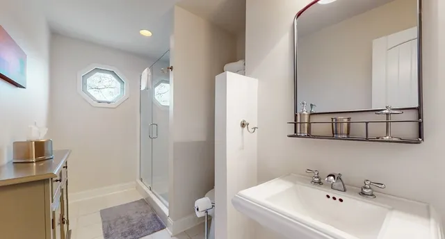 a living room with furniture a fireplace and a floor to ceiling window