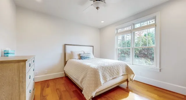 a bedroom with two beds and painting on the wall