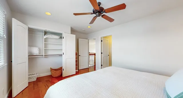a view of a house with a yard and potted plants