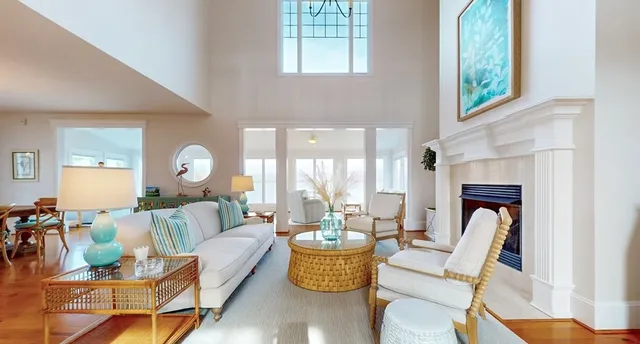 a living room with furniture and floor to ceiling windows