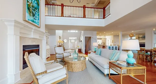 a living room with furniture and floor to ceiling windows