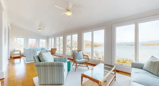 a living room with furniture kitchen view and a large window