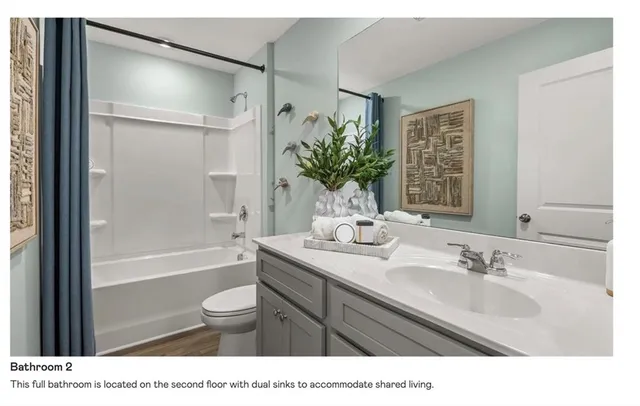 a bathroom with a sink a toilet a tub and shower