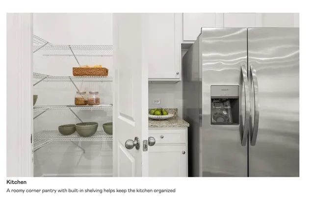 a kitchen with a refrigerator and a stove