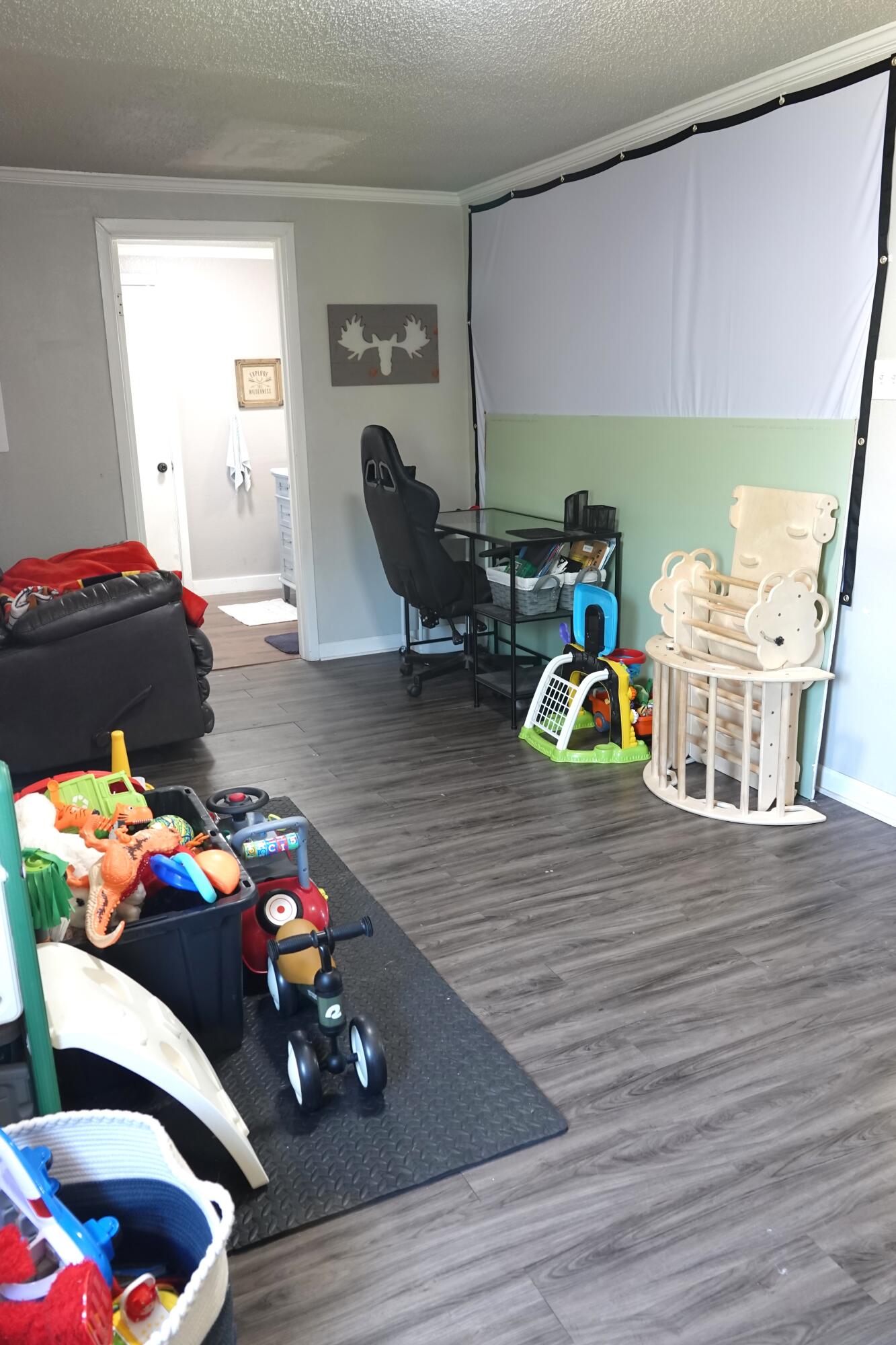 5310 24th Street Lubbock, TX 79407 - Photo 11 of 34 a bedroom with furniture and a wooden floor