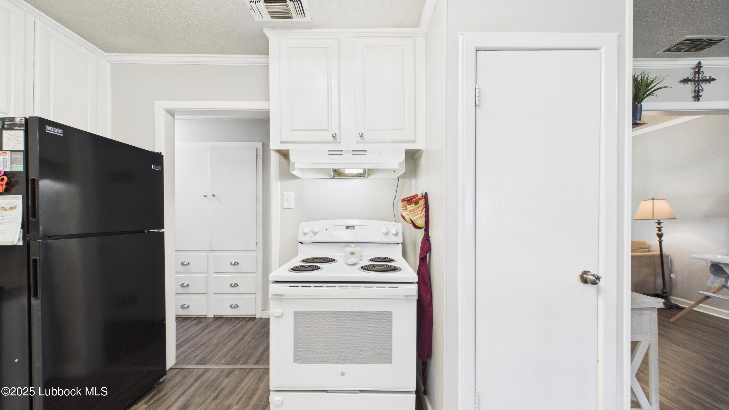 5310 24th Street Lubbock, TX 79407 - Photo 12 of 34 a kitchen with a refrigerator and a stove