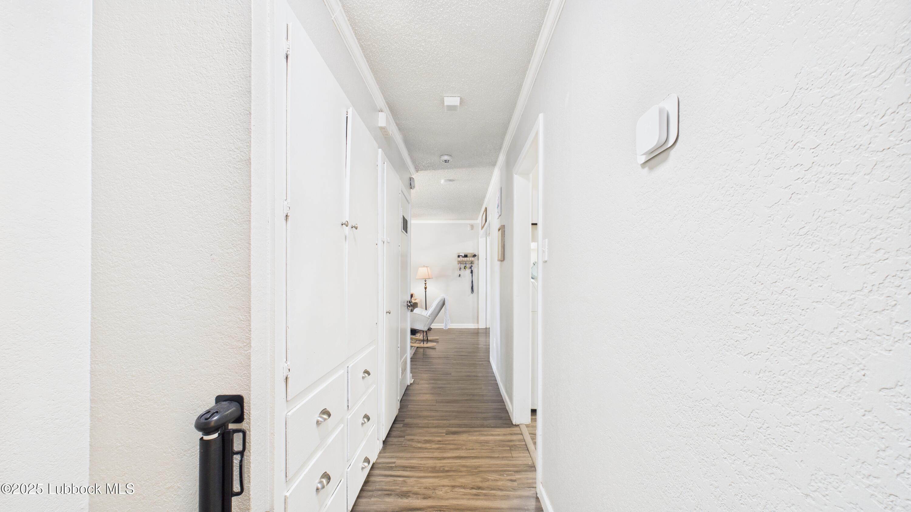 5310 24th Street Lubbock, TX 79407 - Photo 15 of 34 a view of a hallway with wooden floor and staircase