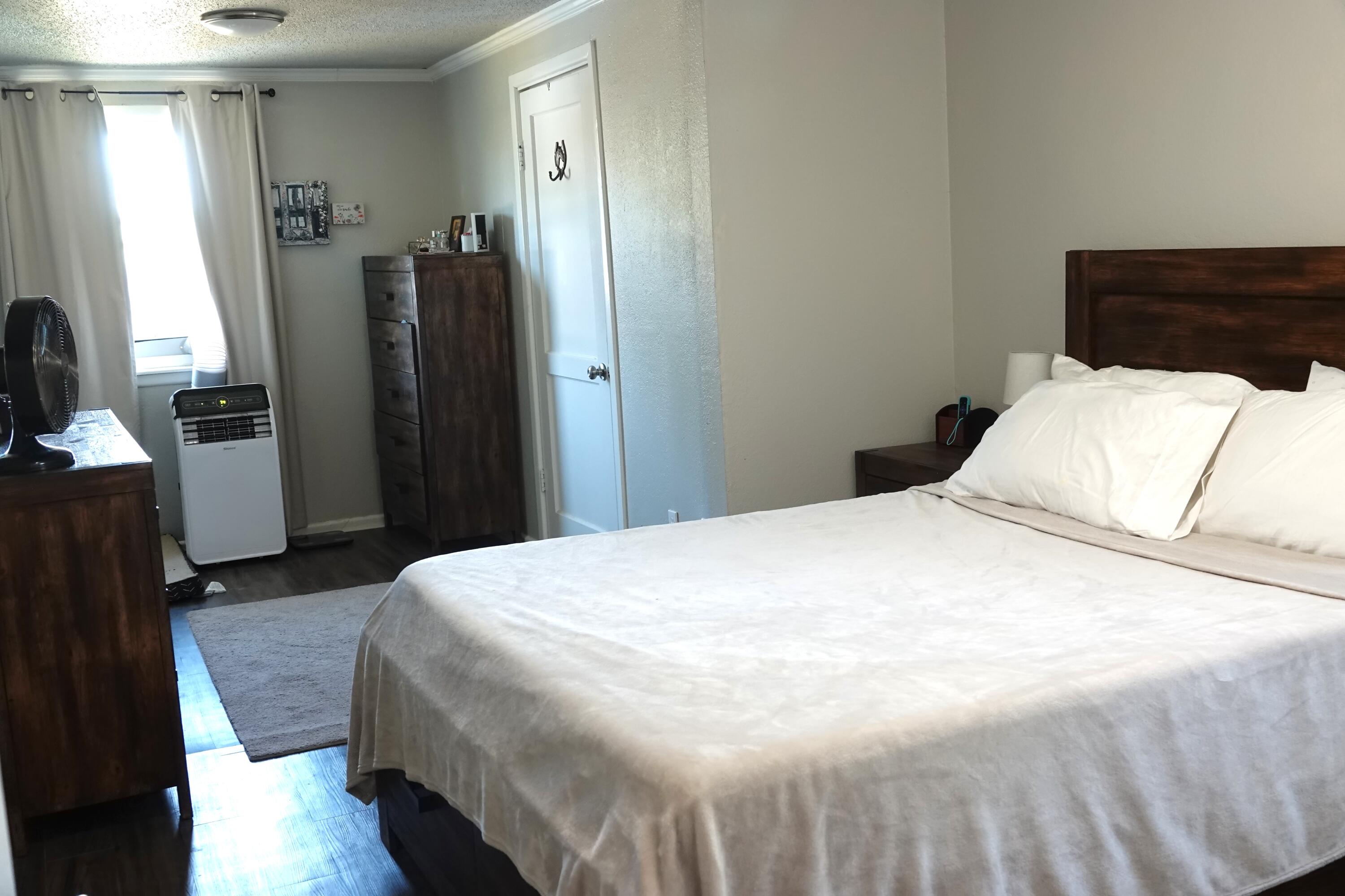 5310 24th Street Lubbock, TX 79407 - Photo 17 of 34 a bedroom with a bed and wooden floor