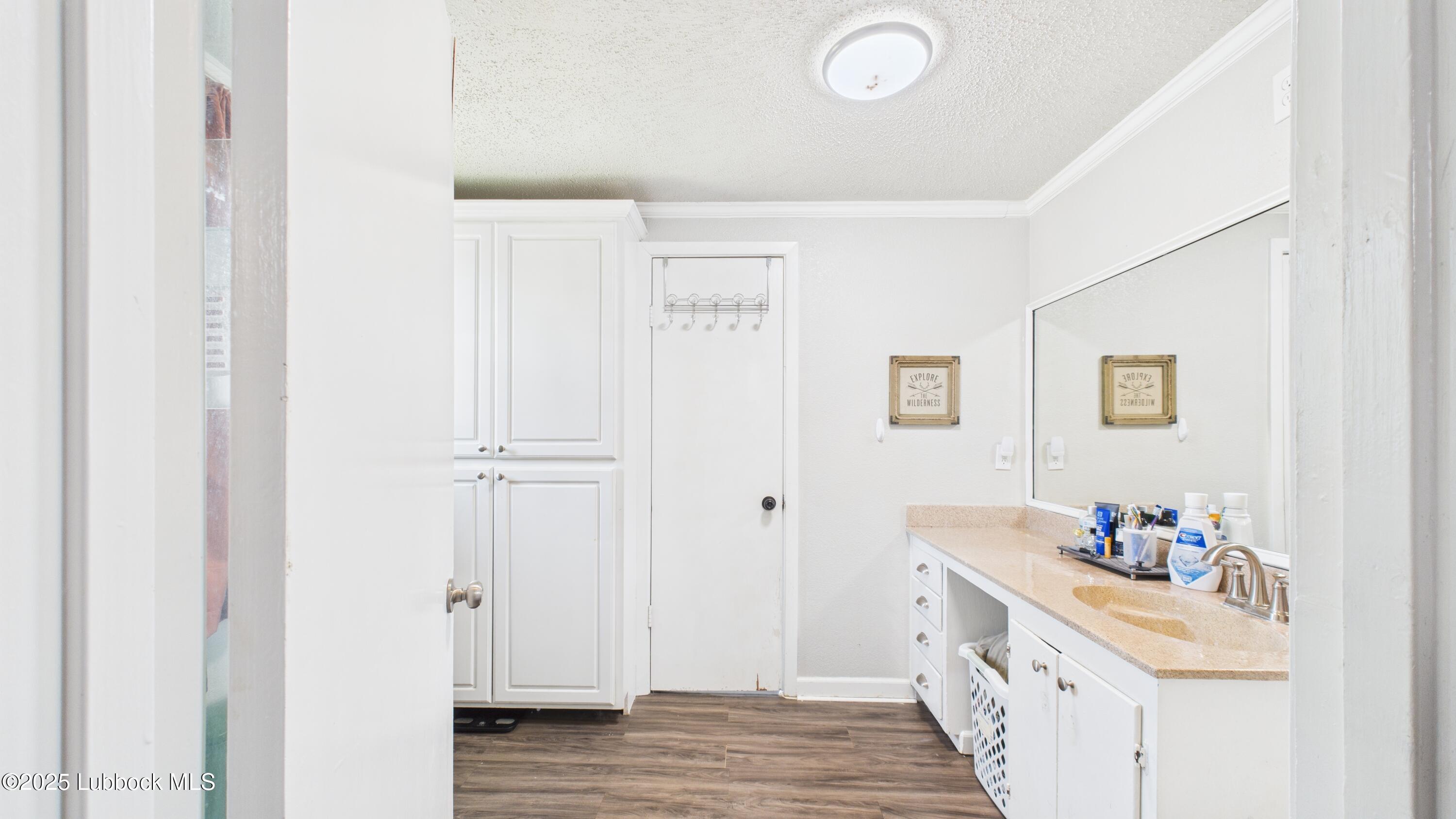 5310 24th Street Lubbock, TX 79407 - Photo 21 of 34 a bathroom with a sink a mirror and a shower