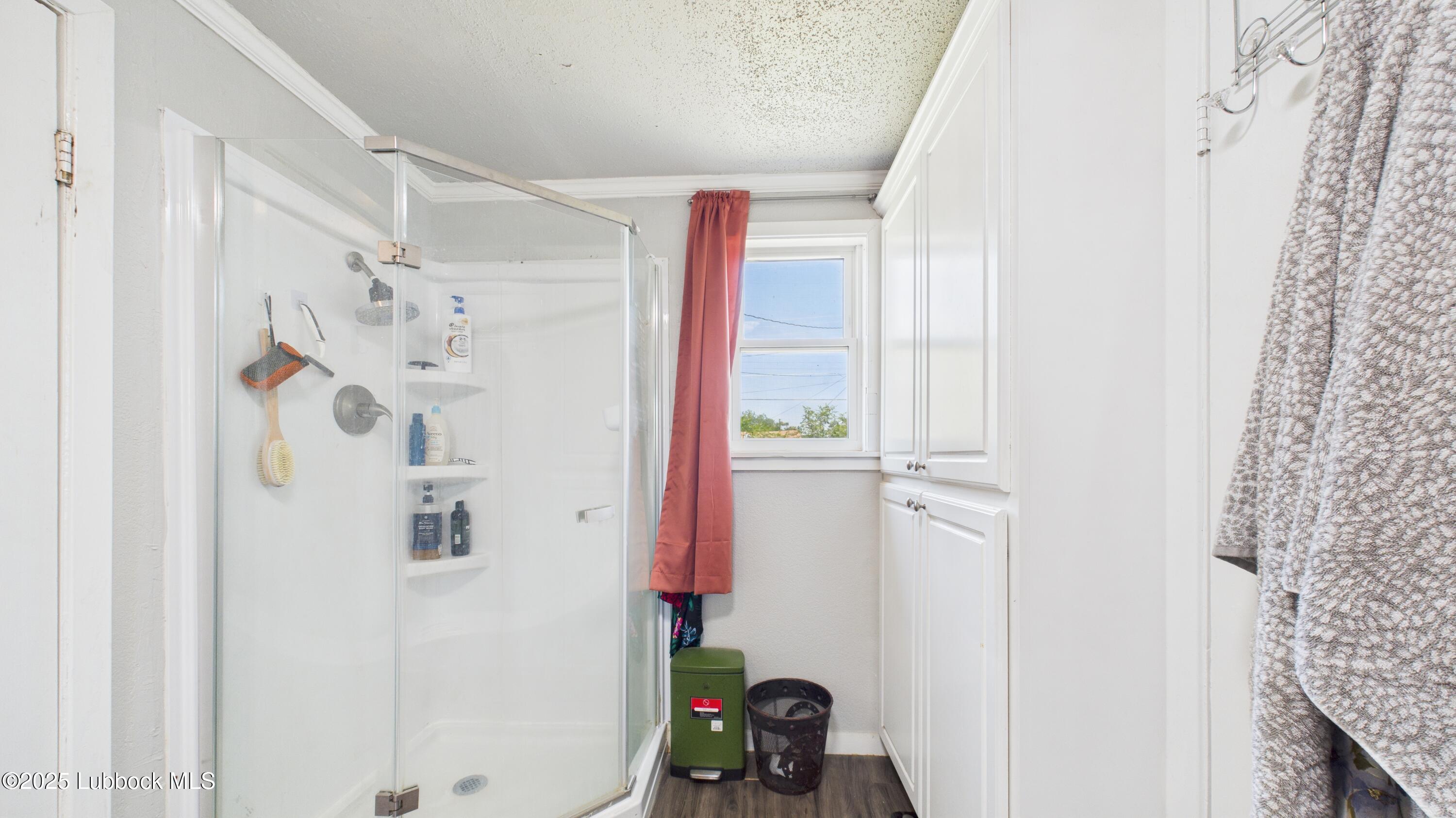 5310 24th Street Lubbock, TX 79407 - Photo 22 of 34 a bathroom with a bathtub and shower curtain