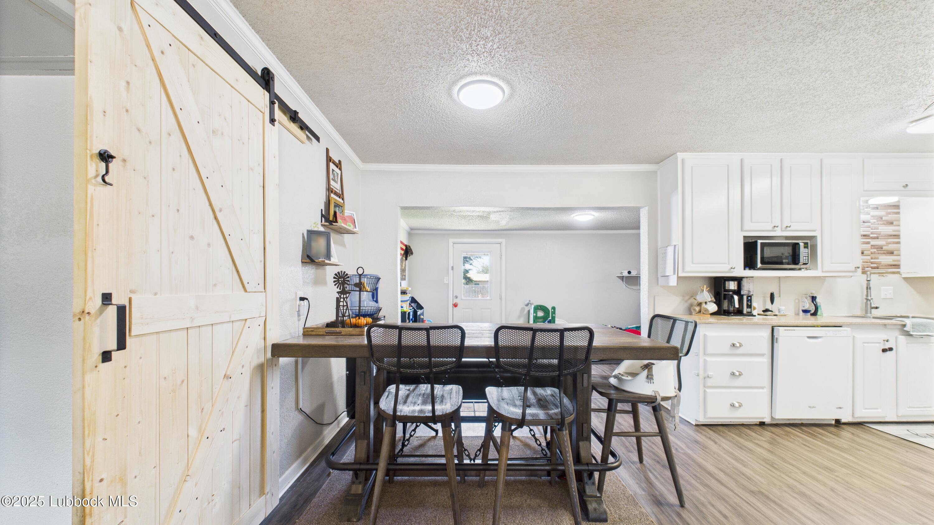 5310 24th Street Lubbock, TX 79407 - Photo 6 of 34 a view of a dining room with furniture and wooden floor