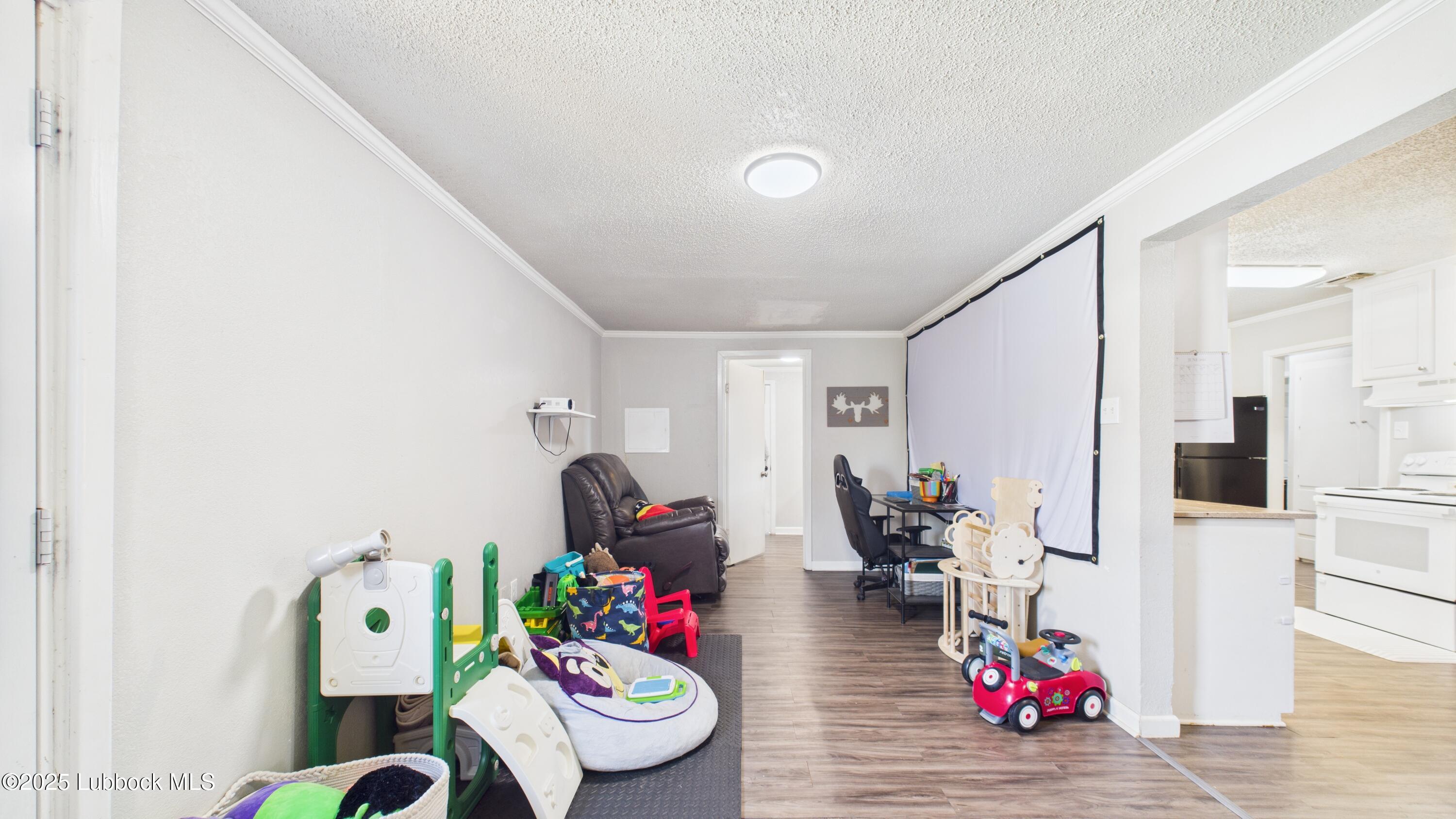5310 24th Street Lubbock, TX 79407 - Photo 10 of 34 a living room with furniture and wooden floor