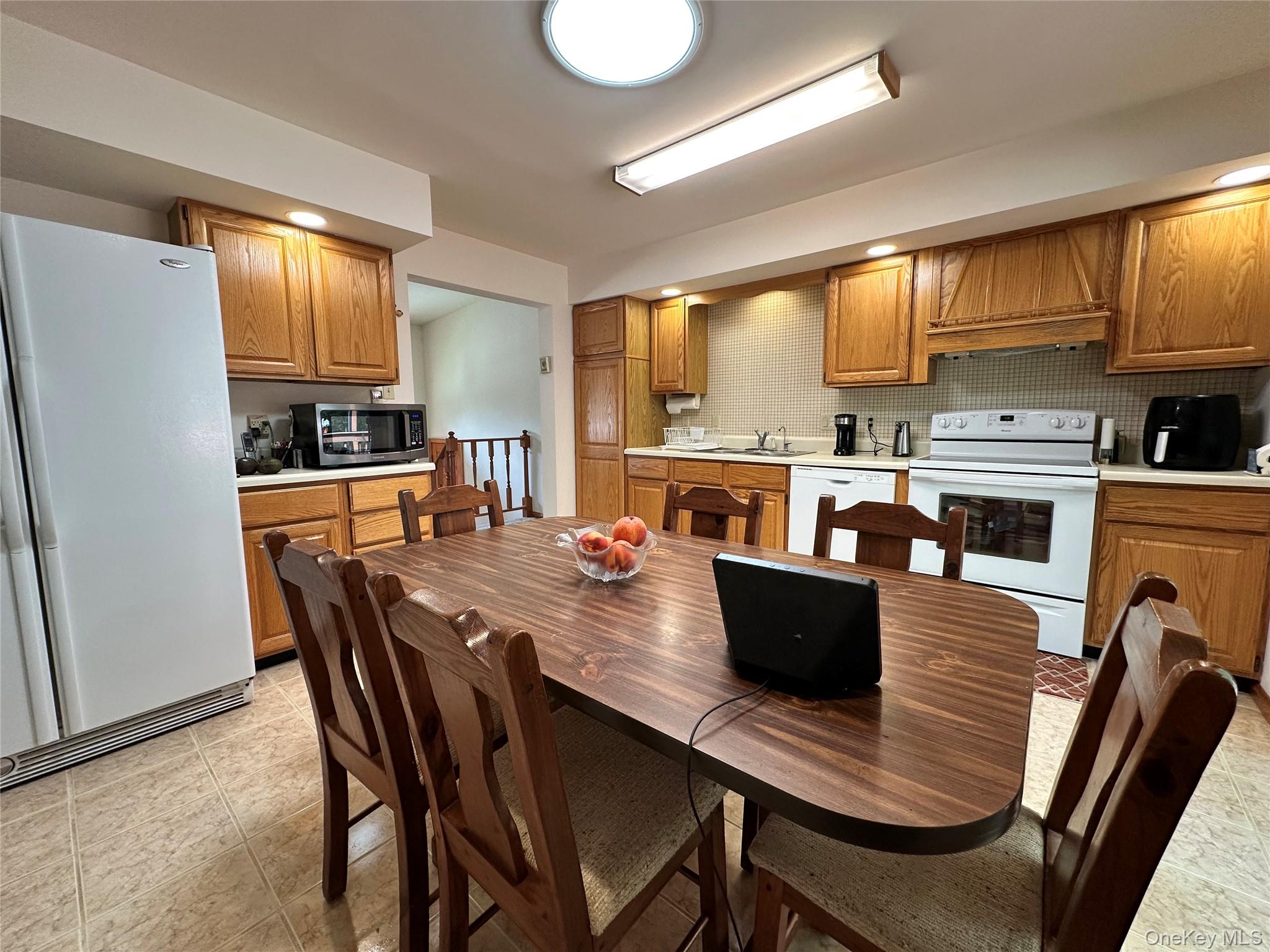 60 Manchester Road Rock Hill, NY 12775 - Photo 11 of 47 a large kitchen with a table chairs and wooden floor
