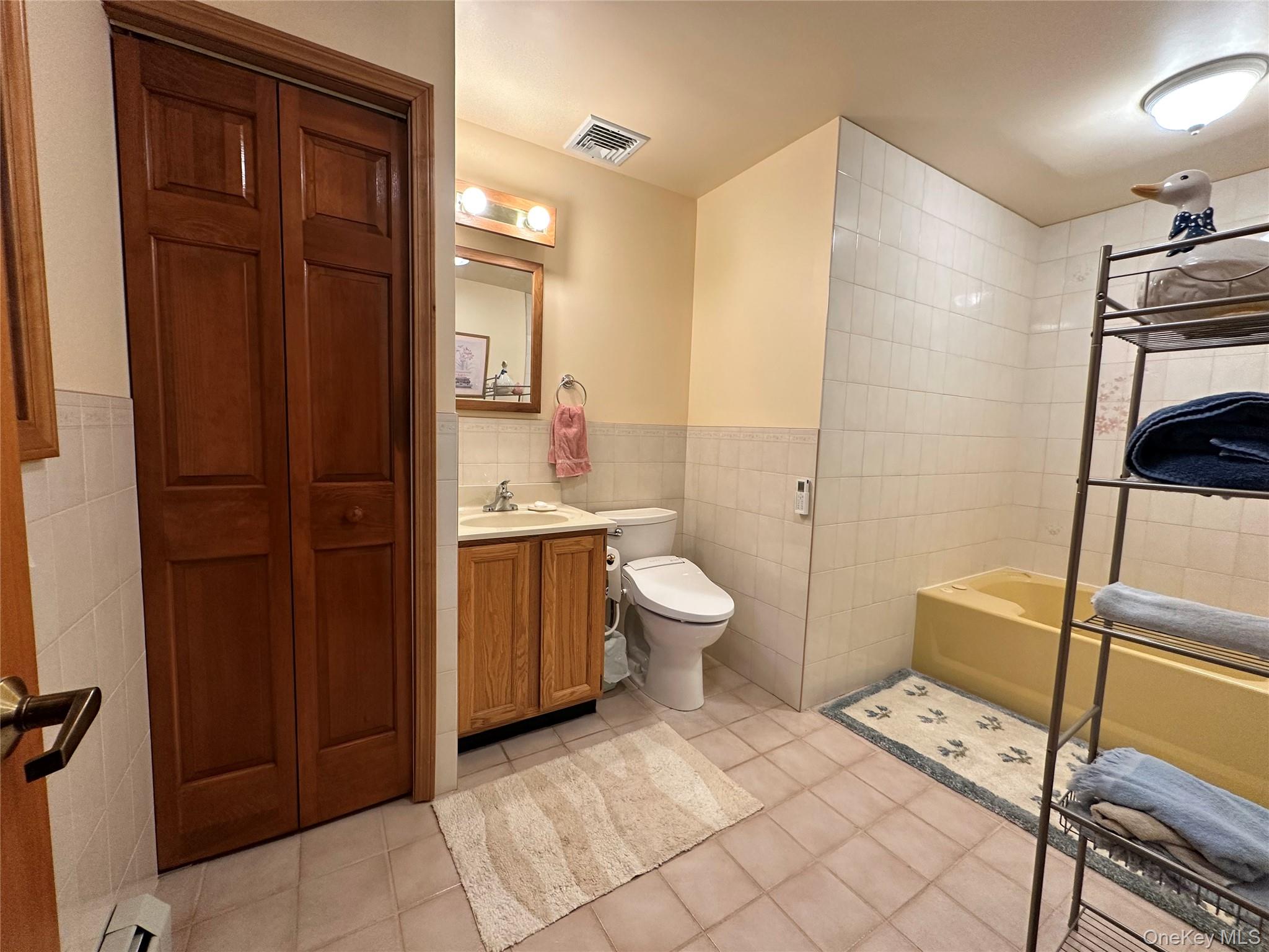 60 Manchester Road Rock Hill, NY 12775 - Photo 22 of 47 a spacious bathroom with a double vanity sink a toilet and a shower