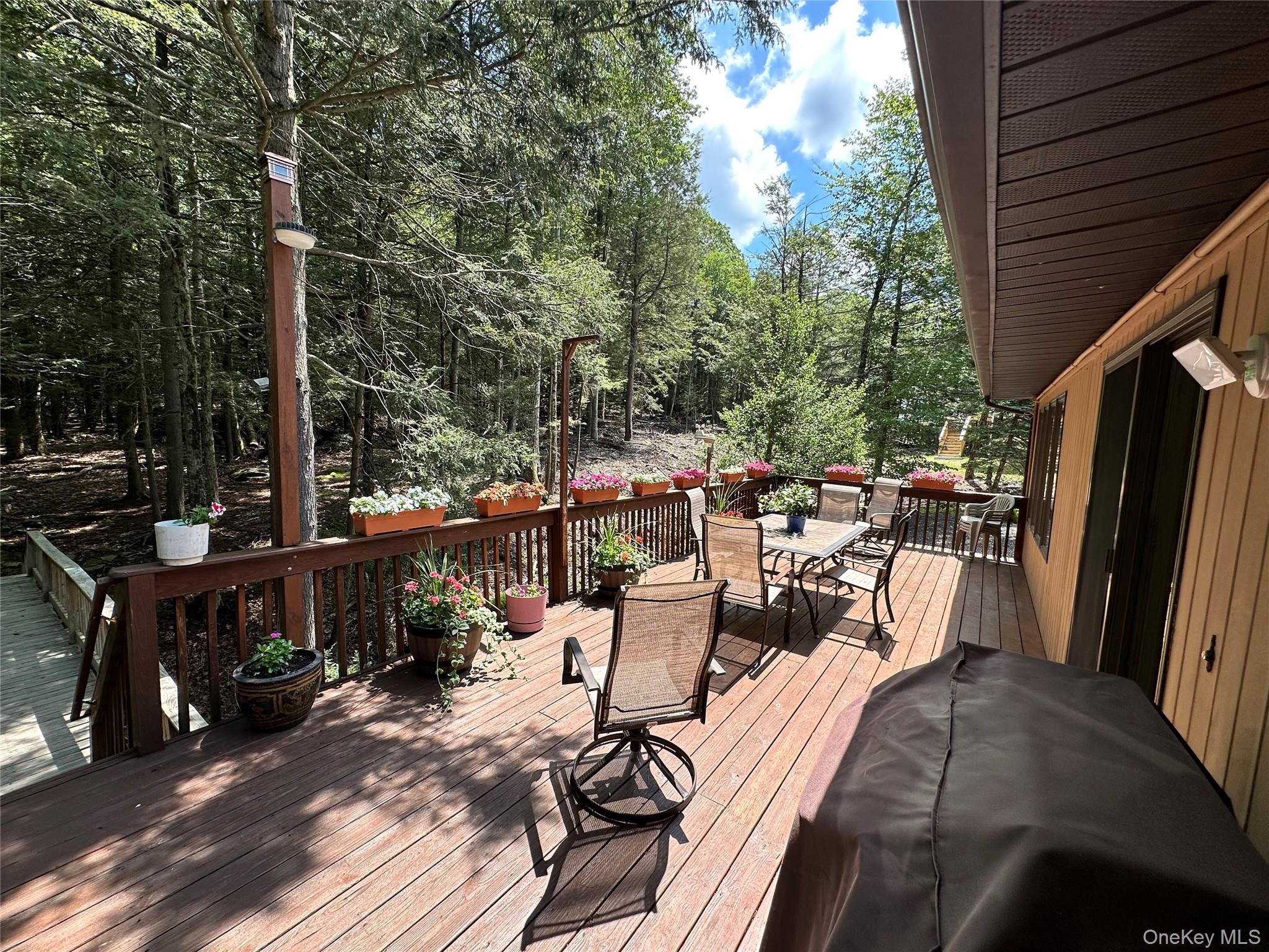 60 Manchester Road Rock Hill, NY 12775 - Photo 35 of 47 a view of a patio with table and chairs and wooden floor