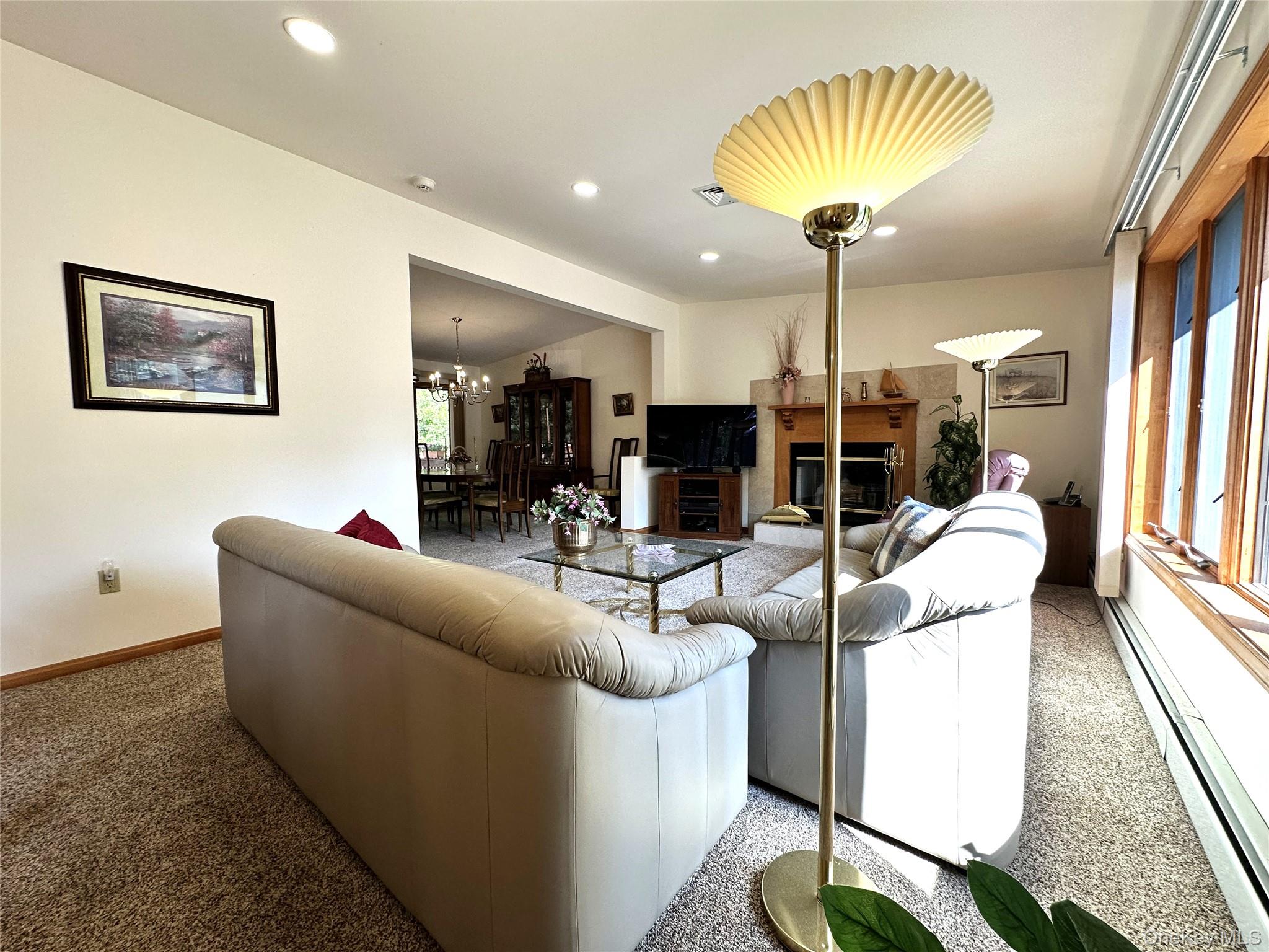 60 Manchester Road Rock Hill, NY 12775 - Photo 4 of 47 a living room with furniture a chandelier and a large window