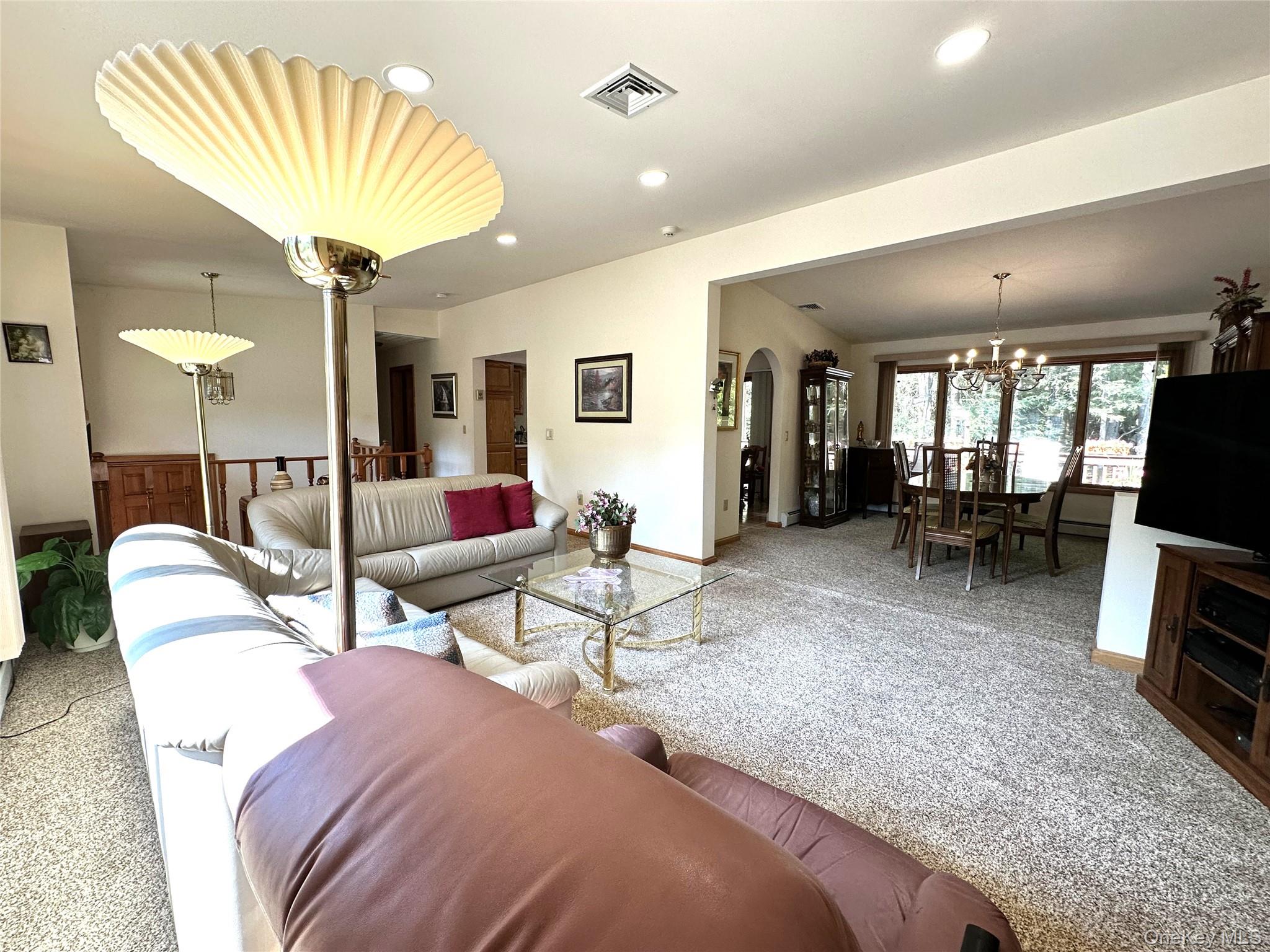 60 Manchester Road Rock Hill, NY 12775 - Photo 5 of 47 a living room with furniture a rug and a chandelier