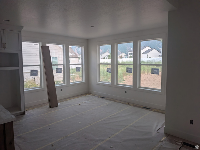 2771 West Aurora Avenue Mapleton, UT 84664 - Photo 8 of 39 Spacious interior with multiple windows, recessed lighting, and built-in cabinetry