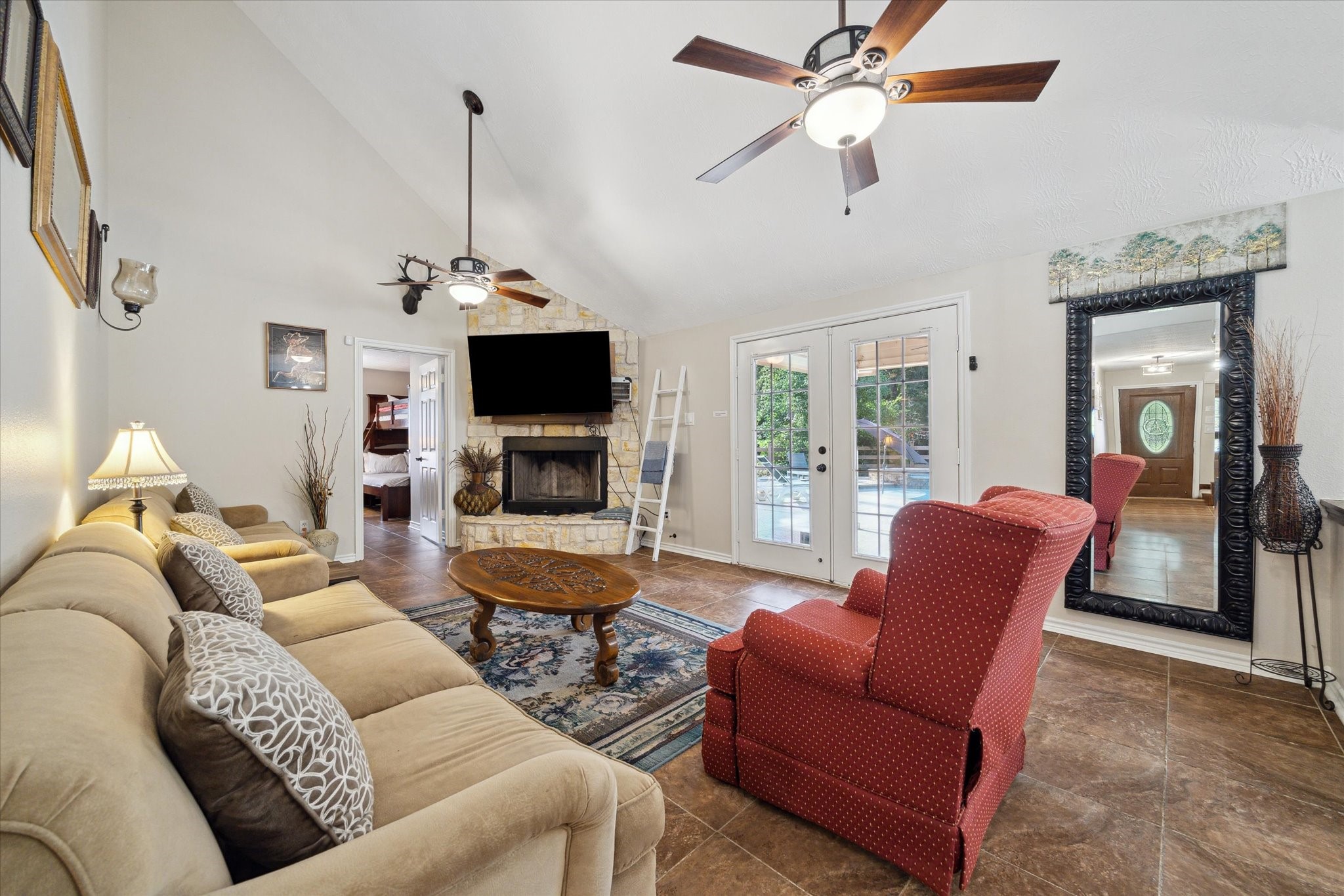 19215 Veterans Road Magnolia, TX 77355 - Photo 12 of 50 a living room with furniture a ceiling fan and a flat screen tv