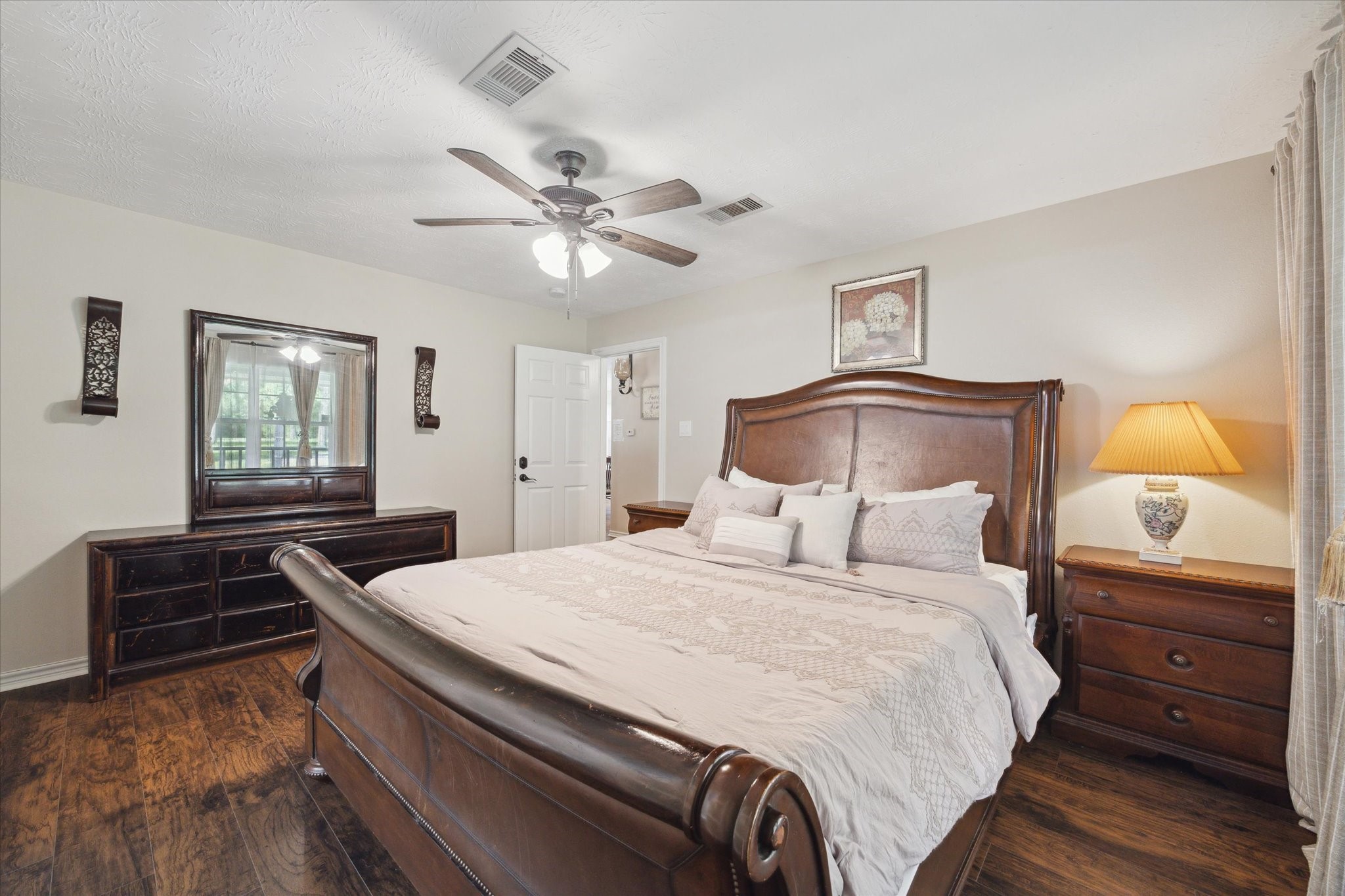 19215 Veterans Road Magnolia, TX 77355 - Photo 20 of 50 a bedroom with a bed and wooden floor