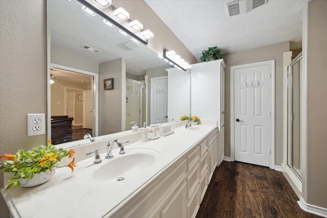 a bathroom with a double vanity sink and a mirror