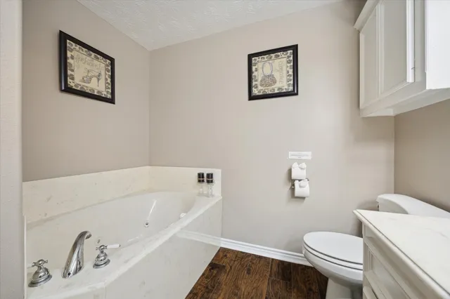 a white bath tub sitting next to a white toilet
