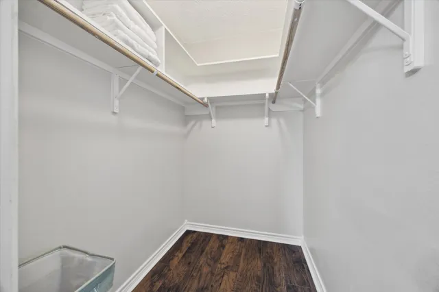 a view of walk in closet with empty racks