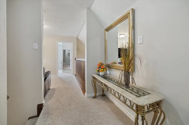 a view of hallway with a mirror and a window