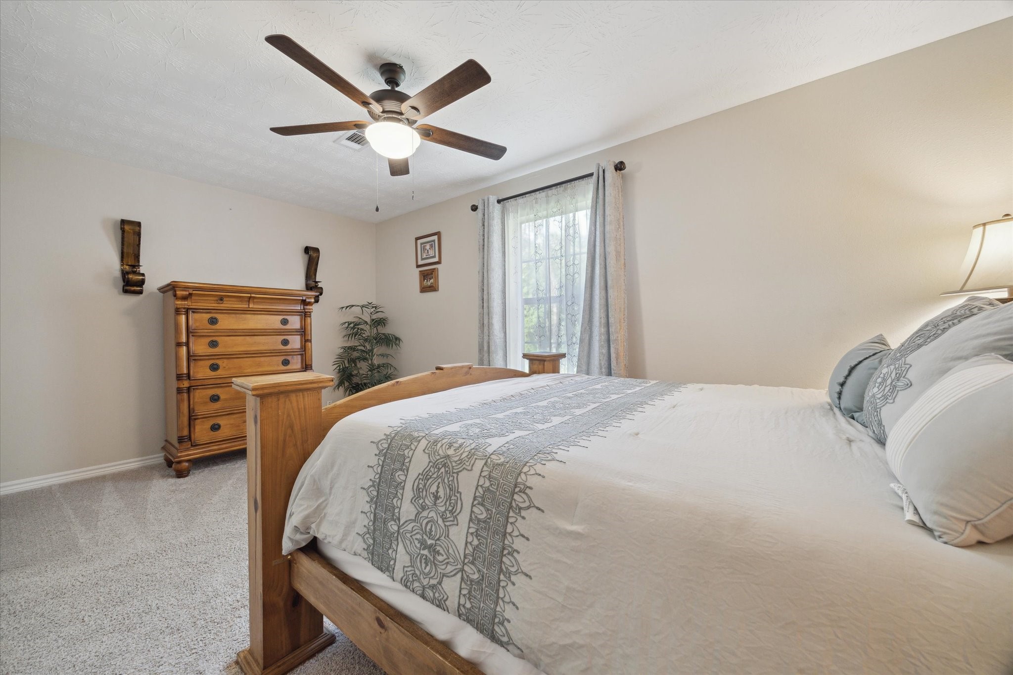 19215 Veterans Road Magnolia, TX 77355 - Photo 29 of 50 a bedroom with a bed and dresser