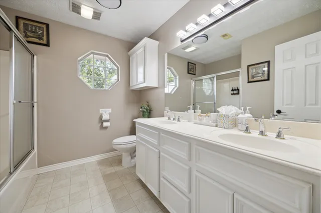 a bathroom with a toilet a sink and a mirror