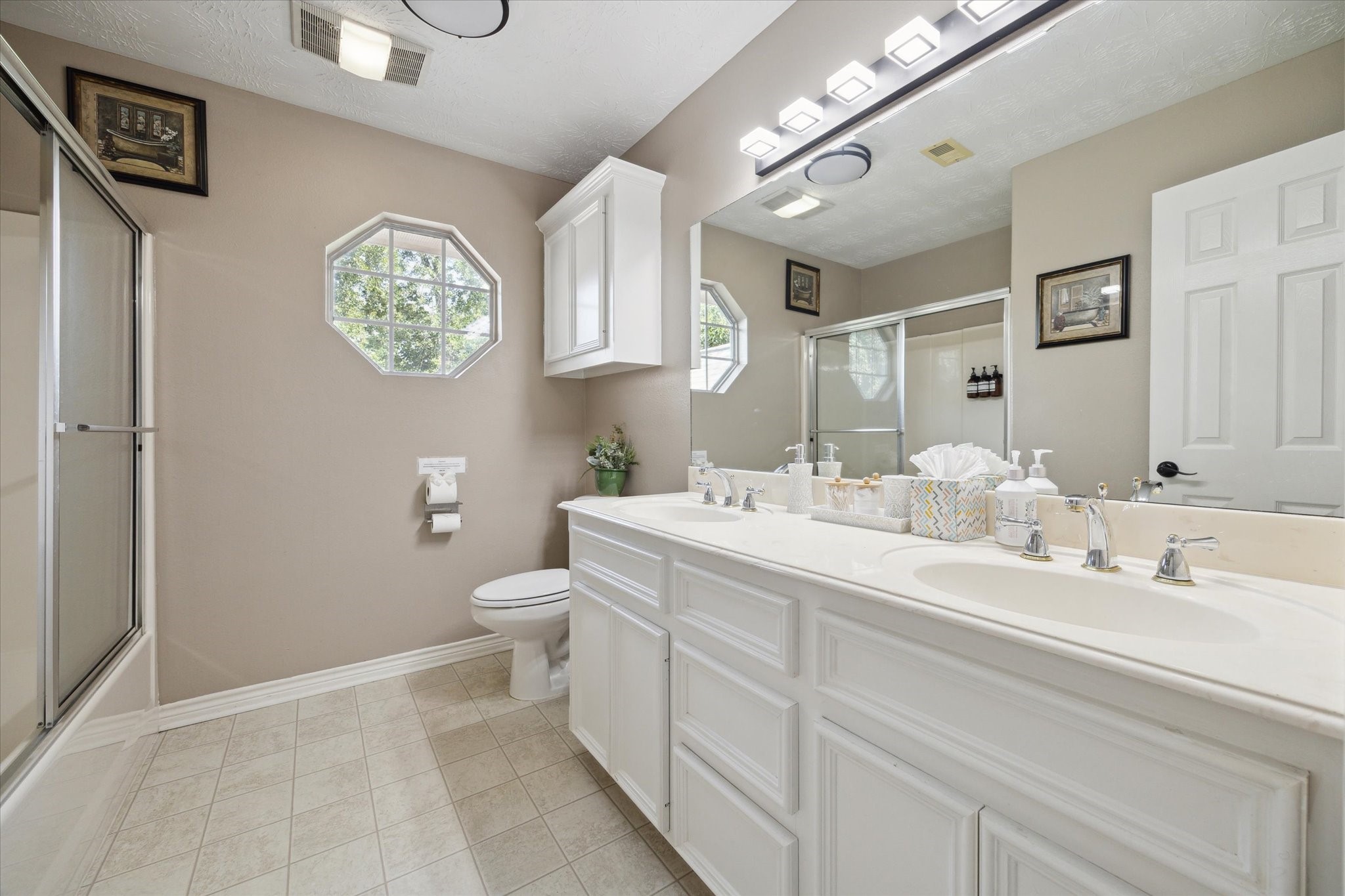 19215 Veterans Road Magnolia, TX 77355 - Photo 33 of 50 a bathroom with a toilet a sink and a mirror