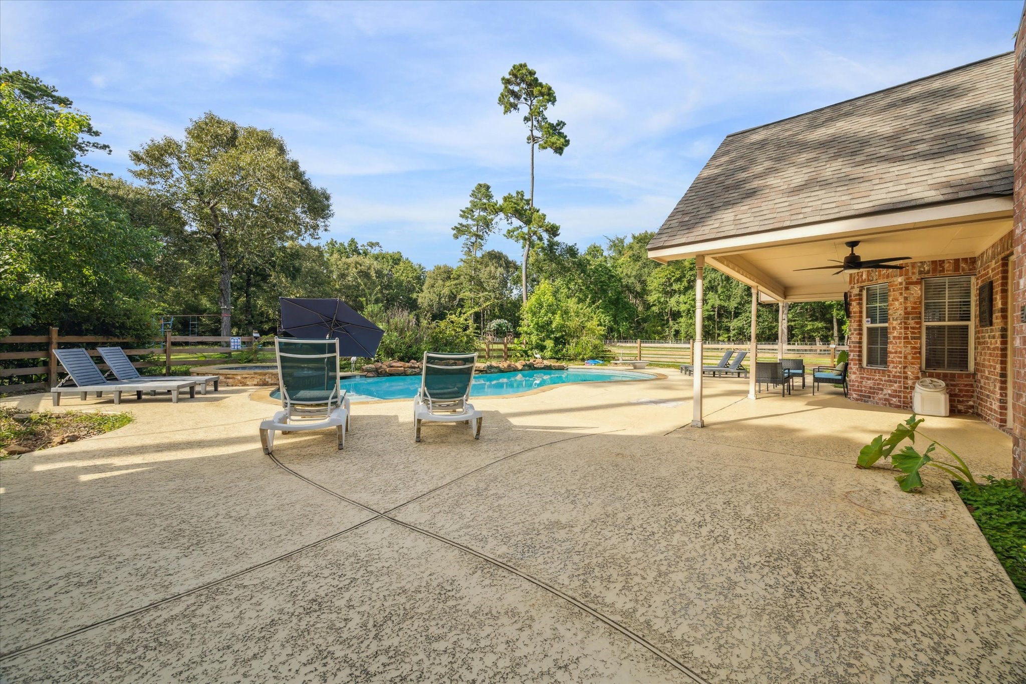19215 Veterans Road Magnolia, TX 77355 - Photo 35 of 50 a view of a swimming pool with a patio