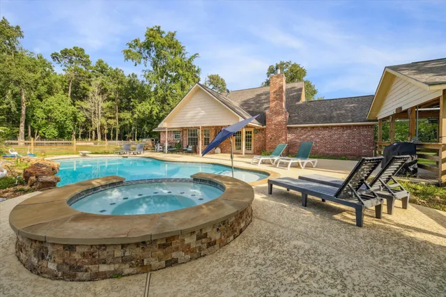 a swimming pool with outdoor seating yard and barbeque oven